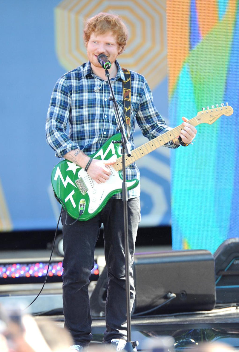 Ed Sheeran playing a unique green Fender Eric Clapton Stratocaster electric guitar by creative director Teddy McDonald  on stage on Multiply world tour.